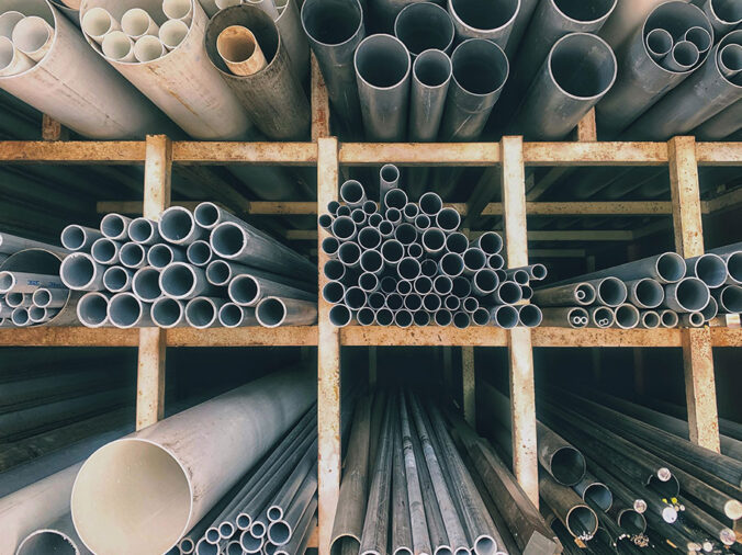 PVC pipes on a shelf in a plumbing supply warehouse