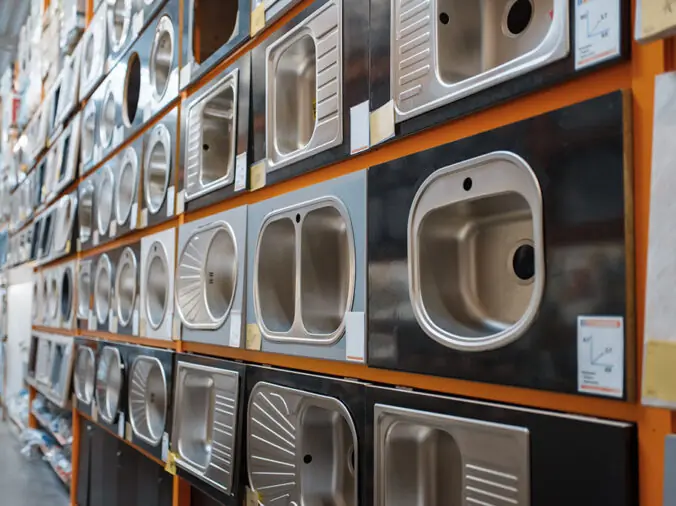 Various kitchen sinks in a plumbing supply warehouse