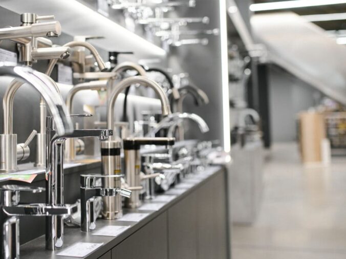kitchen goosenect faucets in a plumbing supply warehouse